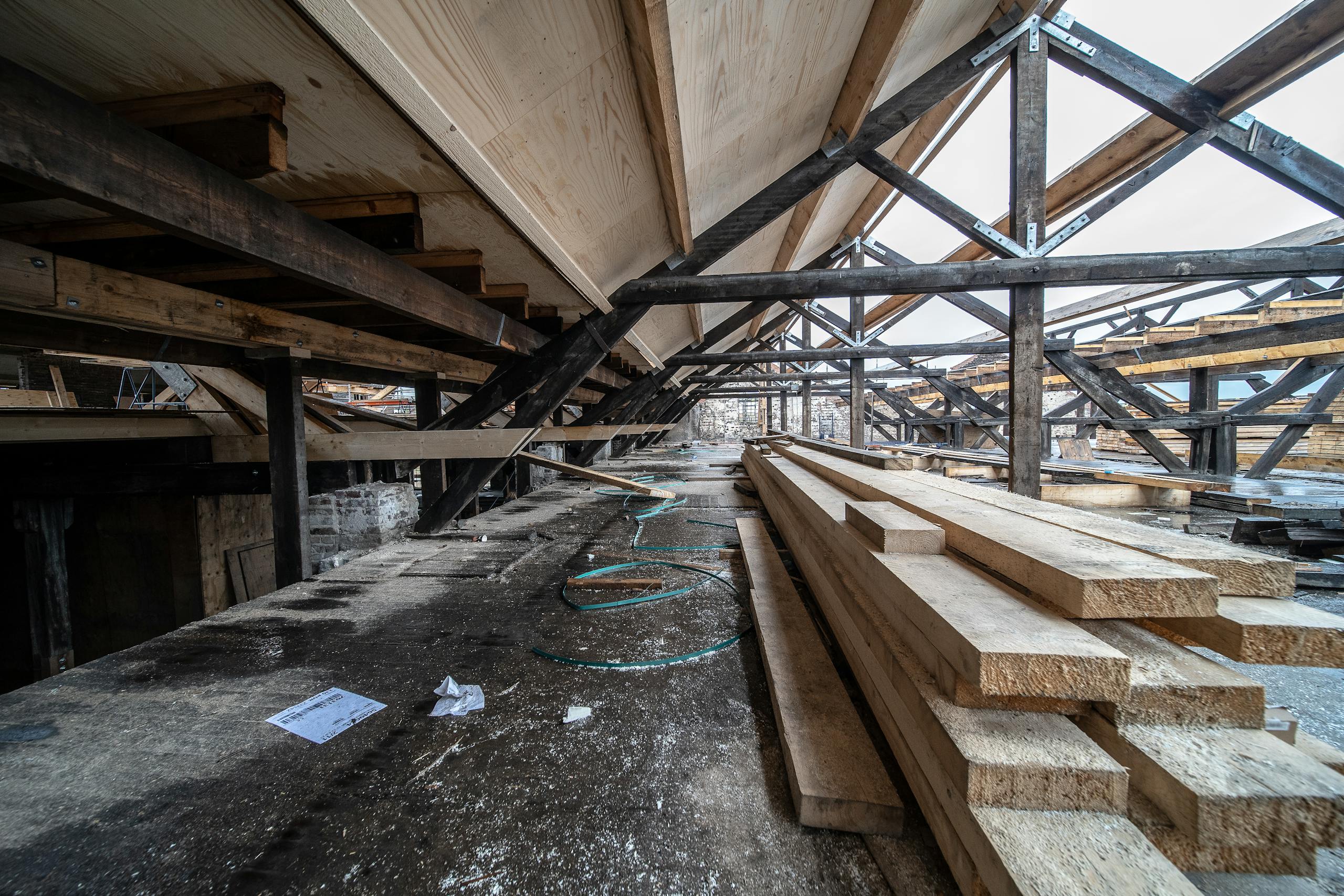 Detailed view of wooden beams in a loft under construction, showcasing structural design and materials.